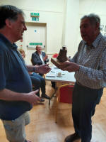 North-East District Ringing Master Philip Gorrod presents Metfield with The Harry Archer Trophy.