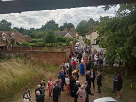 Guests at the wedding enjoying their champagne afterwards in Ufford.