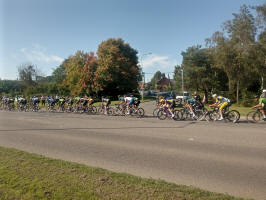 The Tour of Britain peloton passes me in Melton, with the spire of St Andrew's church tower in the background.