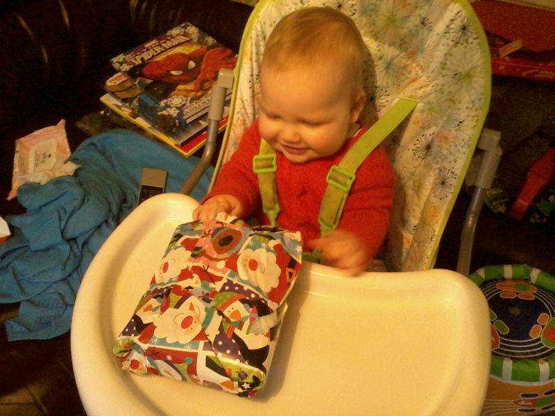 Alfie opens his first ever Christmas present.