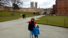 Mason and Alfie in the grounds of Lincoln Castle with the Cathedral behind.