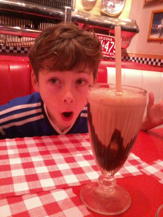 Mason with his 'small' milkshake at the diner.