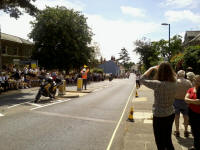 The peloton approaching us outside the Suffolk Coastal offices on Melton Hill...