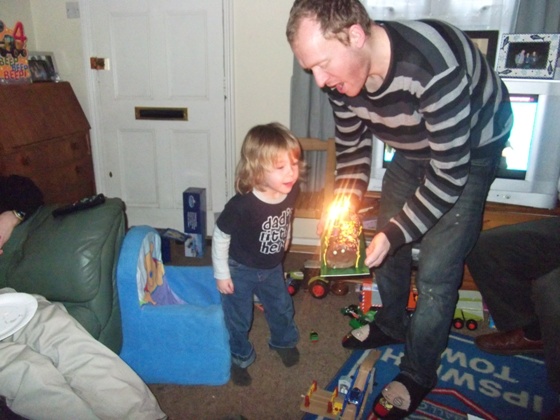 Mason blowing the candles out on his cake