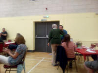 Jason Busby collects the prize for first-place team from Sal Jenkinson at the Guild Social in Holton Village Hall.