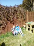 Joshua & Alfie picnicking in the garden.