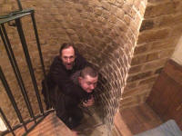 Mike appearing up the tower, carried by Ben.