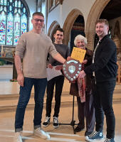 The judges and Diana Pipe present Colin Salter with the certificate and the George W Pipe Trophy for the St Mary-le-Tower band.
