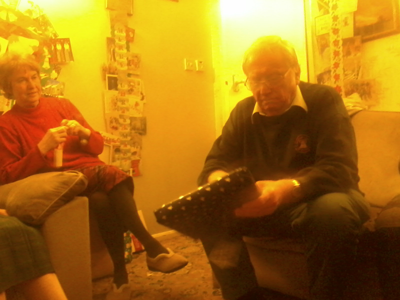 Mum and Dad breaking open their presents on Christmas Day.