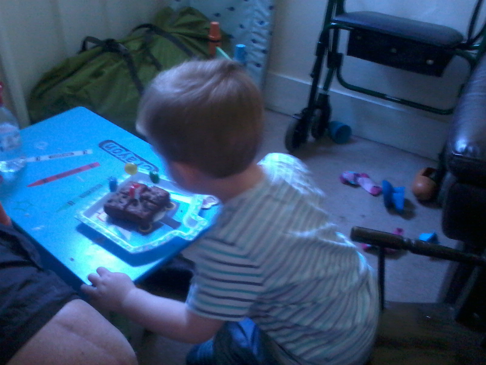 Alfie blowing out the candles on his birthday cake.