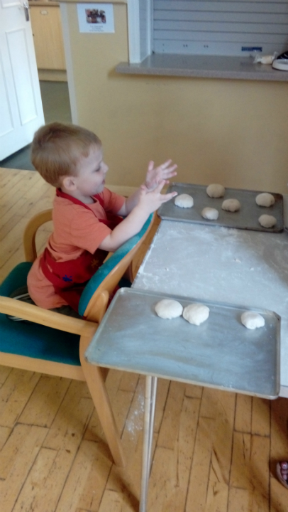 Alfie helping make bread at Sunday School.