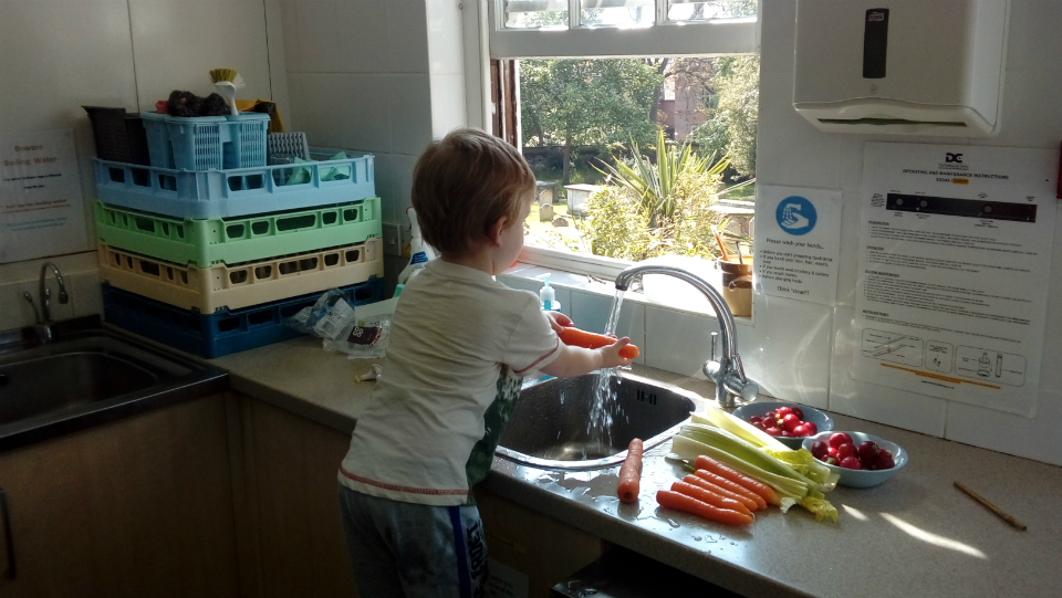 Alfie easing salad in preparation for the church BBQ.