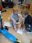 Joshua opening his presents, with help from Alfie.