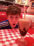 Mason with his 'small' milkshake at the diner.