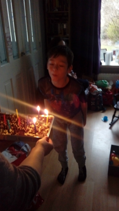 Mason blowing out the candles on his birthday cake.