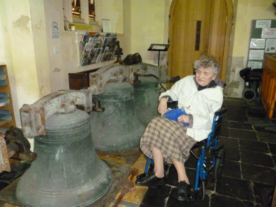 Aunty Marian with the bells of St Margaret's Ipswich on the church floor.