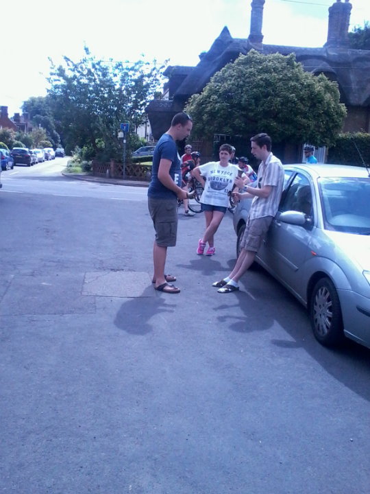 Harm Jan de Kok and Chris Woodcock ringing handbells opposite Waresley church on Rambling Ringers Tour.
