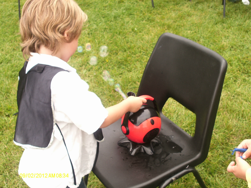  Mason operates the bubble machine at the party.