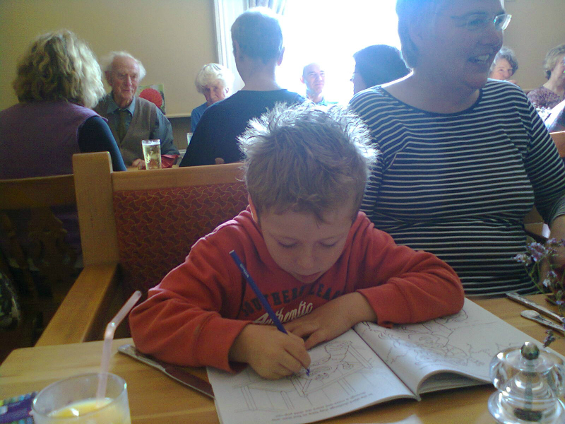 Mason concentrating on his drawing at The Five Bells at Burwell.